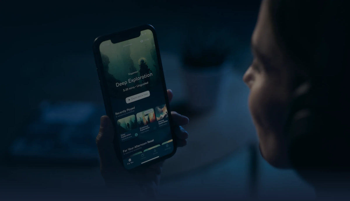 Person using the Lumenate app on a phone in a dark room
