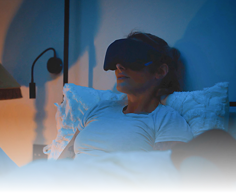Woman wearing Lumenate Nova in bed for sleep