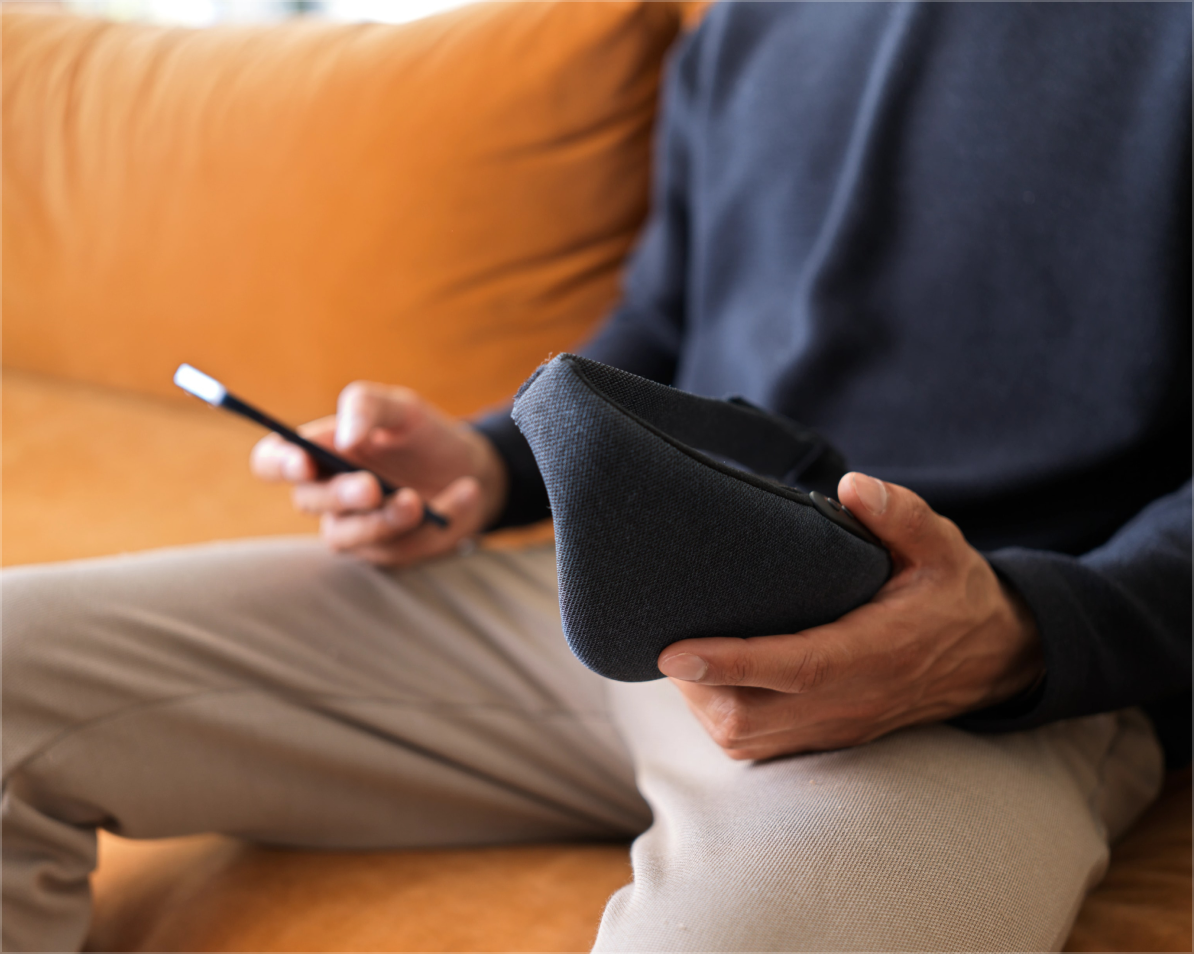 Man holding Lumenate Nova whilst using the Lumenate app